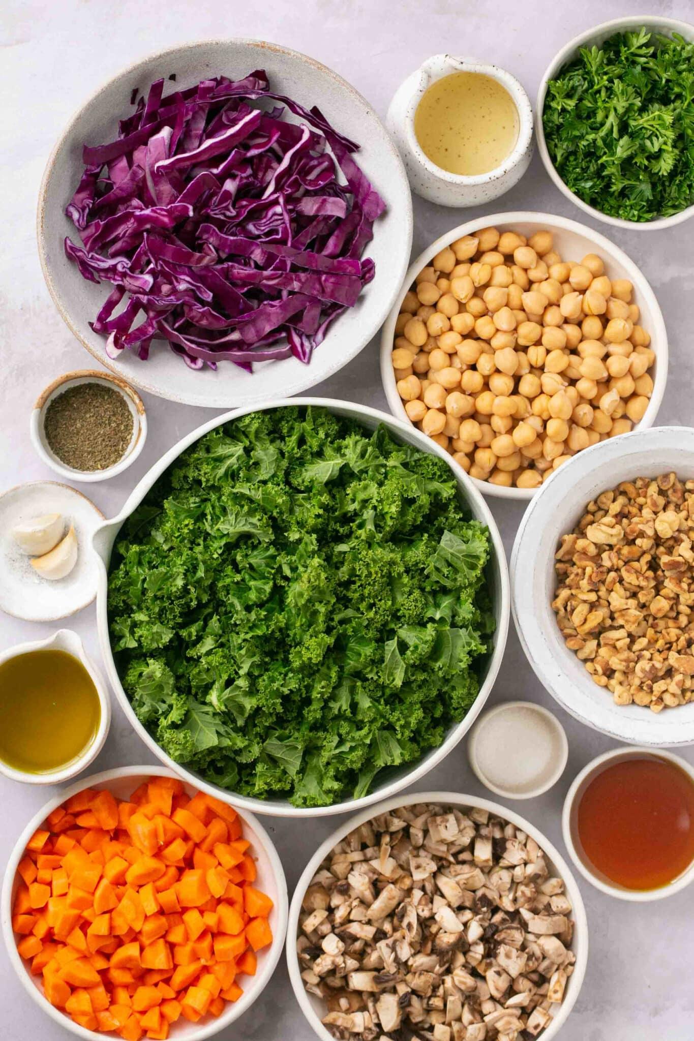 Ingredients for a salad divided into white bowls.