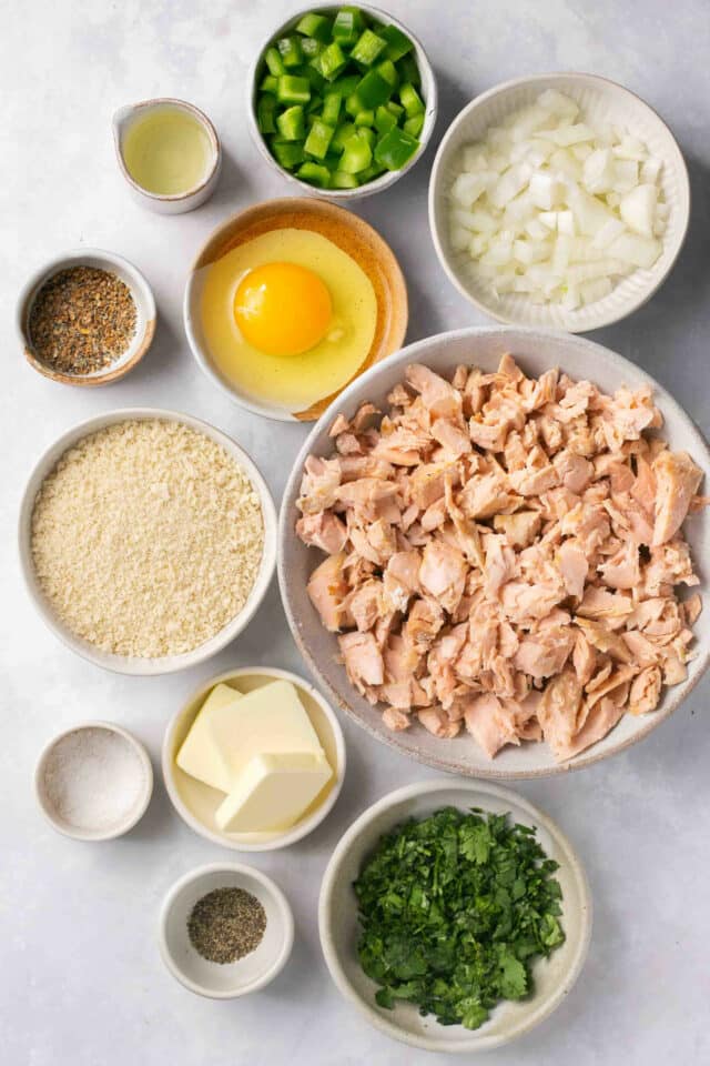 Ingredients to make salmon croquettes divided into small bowls.