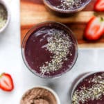 chocolate protein shake in a glass and topped with chia seeds