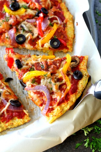 This easy, light cauliflower pizza crust is—dare I say it—the BEST ever and even better than regular pizza crust. Loaded Pizza on Cauliflower Crust will satisfy even the most intense pizza craving. Low-carb, low-calorie, gluten-free and vegetarian, this pizza is figure-friendly and an absolute must try!