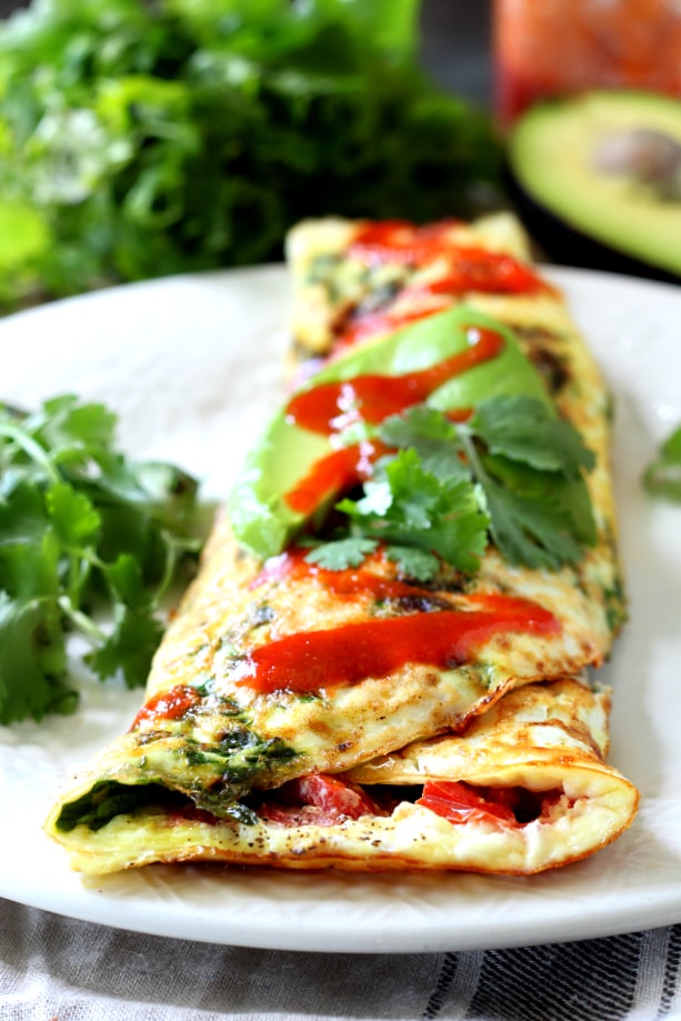 Uber healthy, totally delicious and probably the easiest thing you’ll ever make in your kitchen, this Skinny Egg White Omelet with spinach and tomato is where it's at if you're looking to get lean.