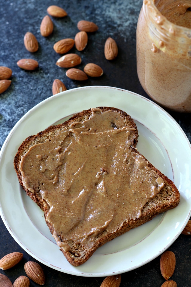 This recipe for an easy homemade Maple Cinnamon Almond Butter just might be the world's BEST almond butter recipe. This stuff is addicting, y'all! I dare you to not eat this yummy stuff by the spoonfuls, straight out of the jar!!