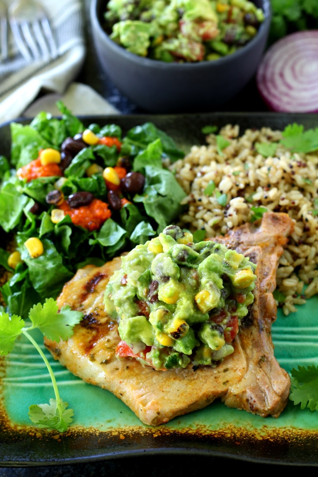 This recipe for Cilantro Lime Grilled Pork Chops With Southwestern Guacamole is beyond flavorful and so EASY to make too! The pork chops cook up in less than 10 minutes on the grill and come out super juicy and incredibly tasty.