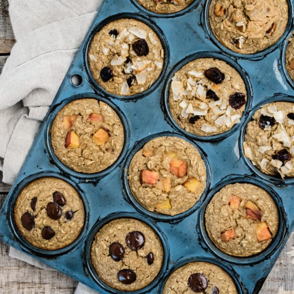 oatmeal muffins with different toppings in a muffin pan