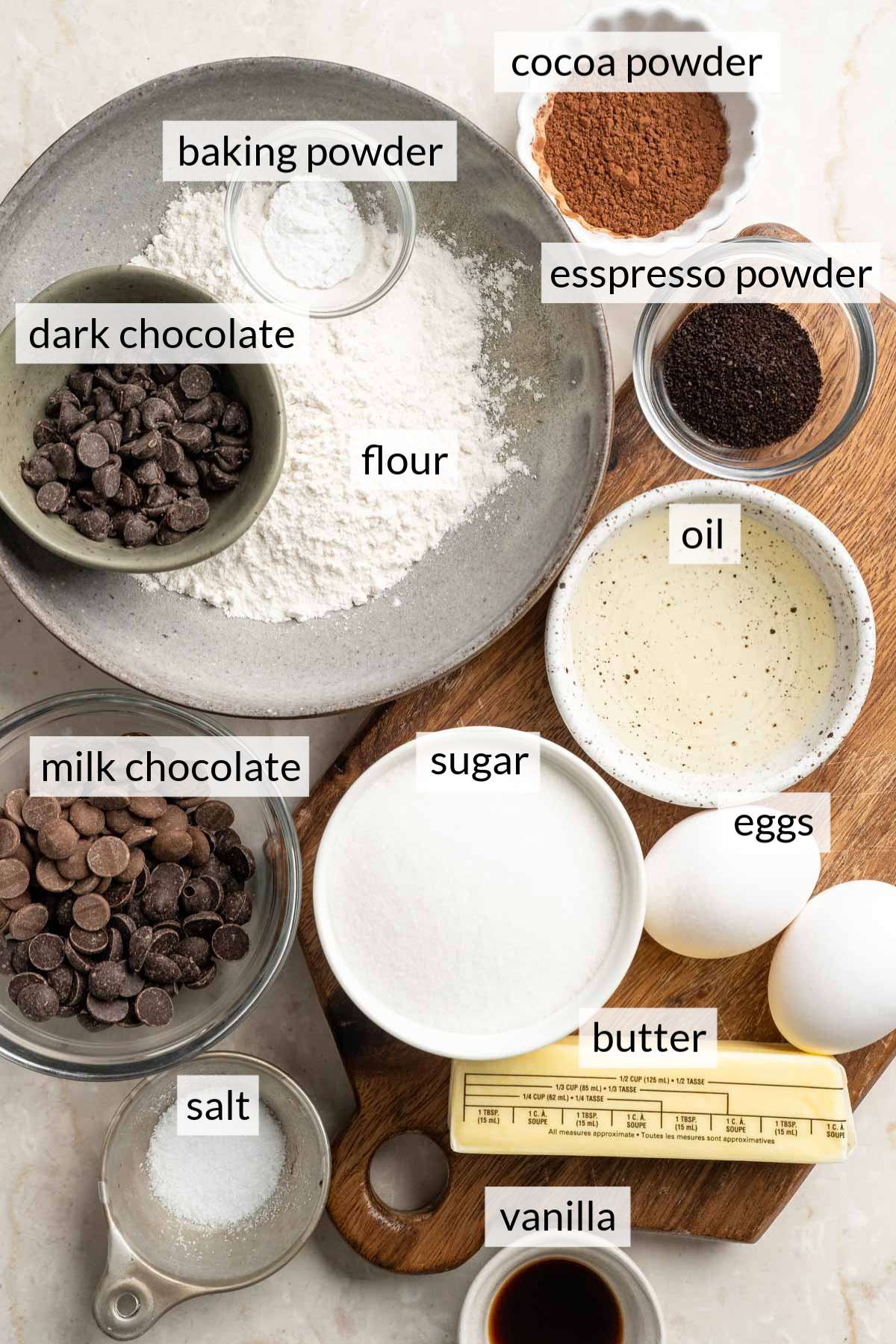 Small bowls with flour, oil, chocolate chips and eggs.