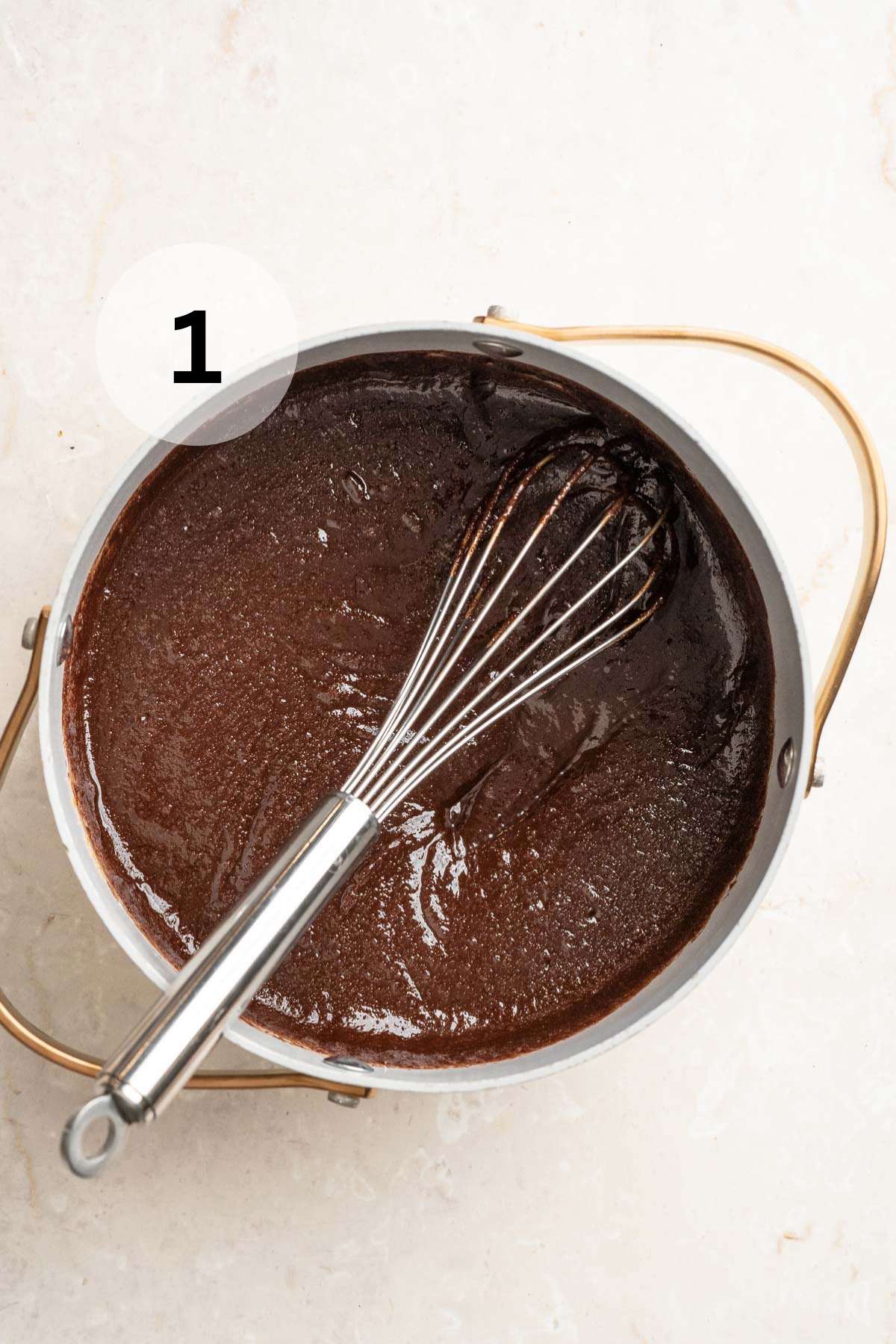 Whisk stirring chocolate in a pot.