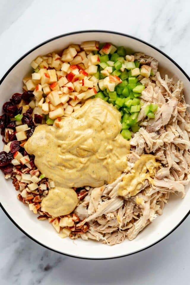 Curry dressing over shredded chicken, chopped apple, celery, pecans and cranberries.
