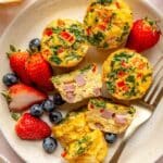 Egg muffins on a plate with fresh berries.