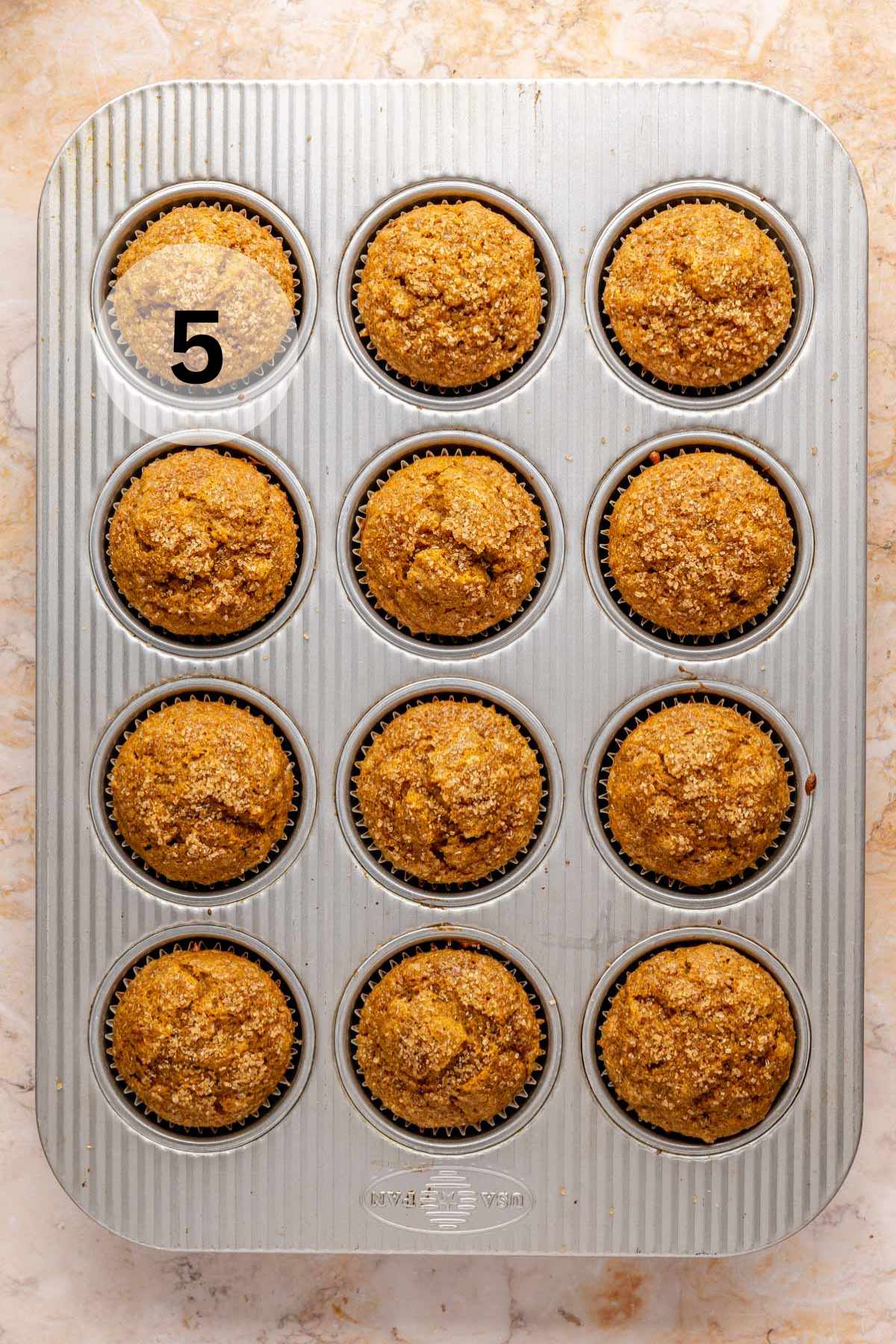 Baked pumpkin banana muffins in a muffin pan.