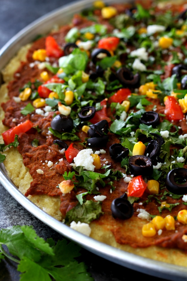 Lots of yummy flavor in this Gluten-Free Taco Pizza! All of your favorite taco ingredients combine atop a gluten-free pizza crust for an amazing dinner!
