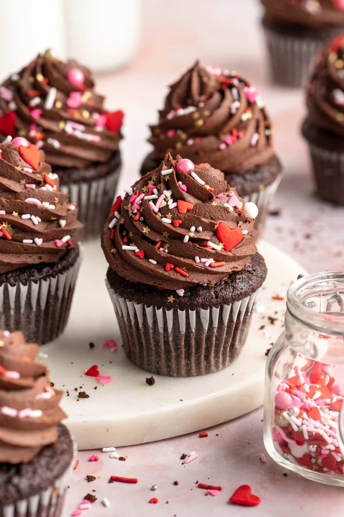 Chocolate cupcakes with frosting and Valentine sprinkles.