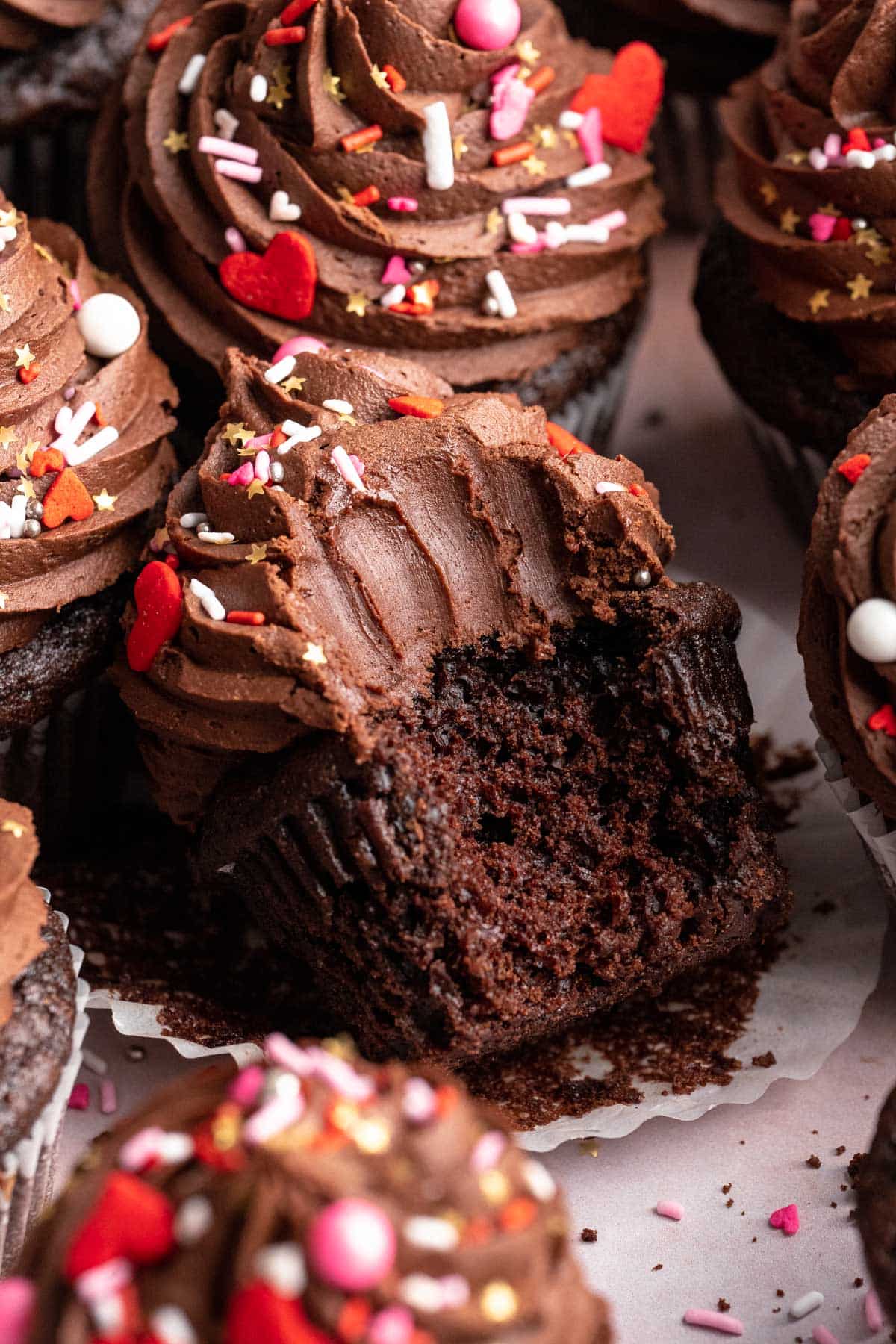 A chocolate cupcake with a bite taken out.