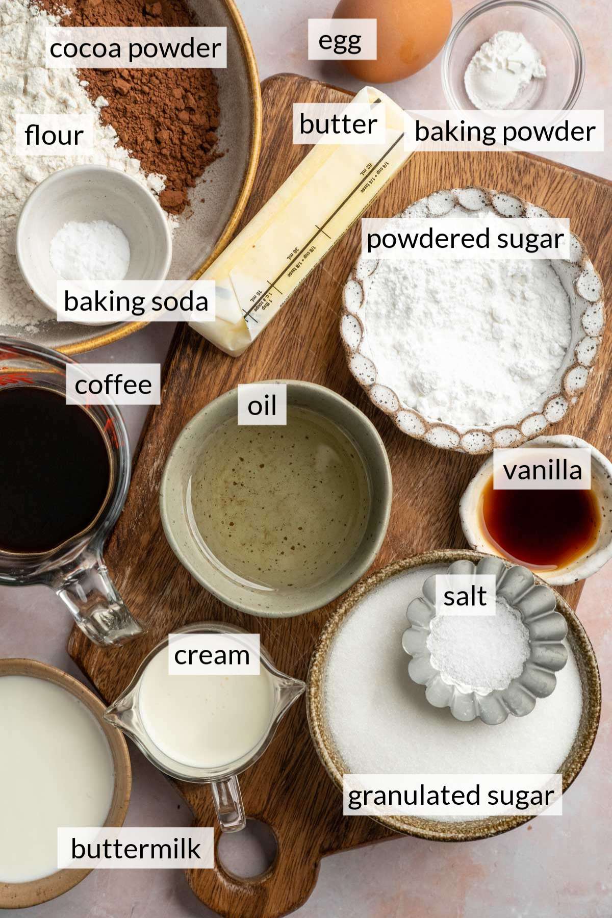 Small bowls with flour, cocoa powder, sugar, oil and vanilla.