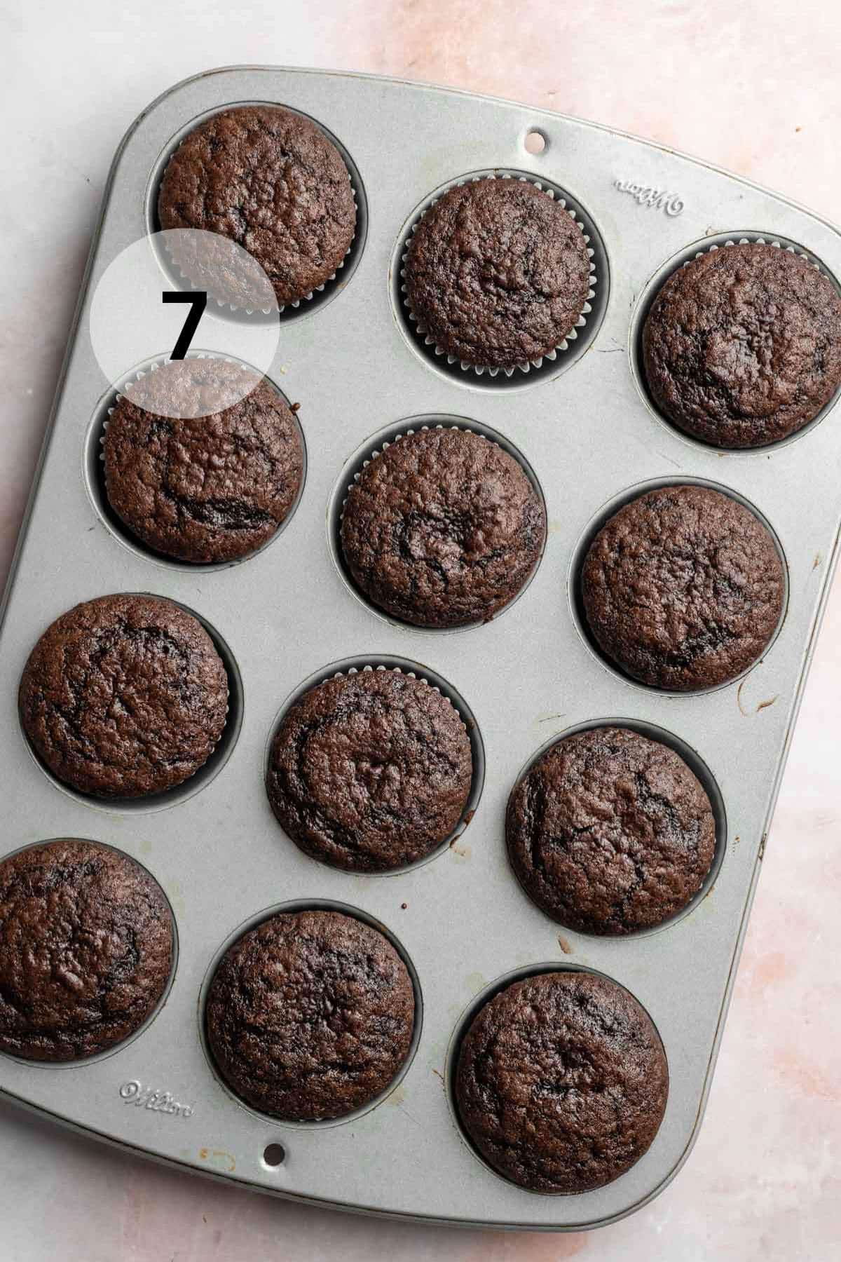 Chocolate cupcakes in a muffin pan.