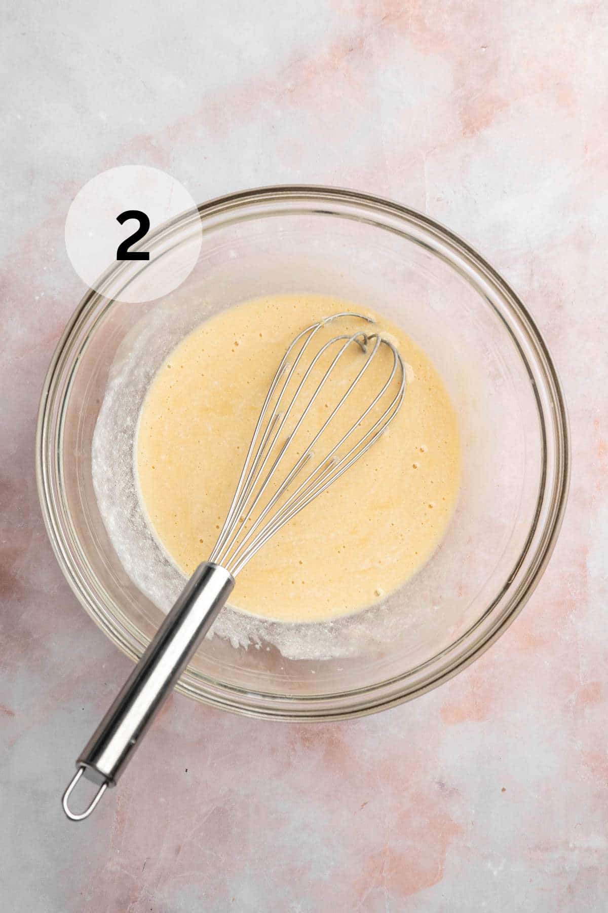 Whisking oil, egg, vanilla, and milk in a large bowl.