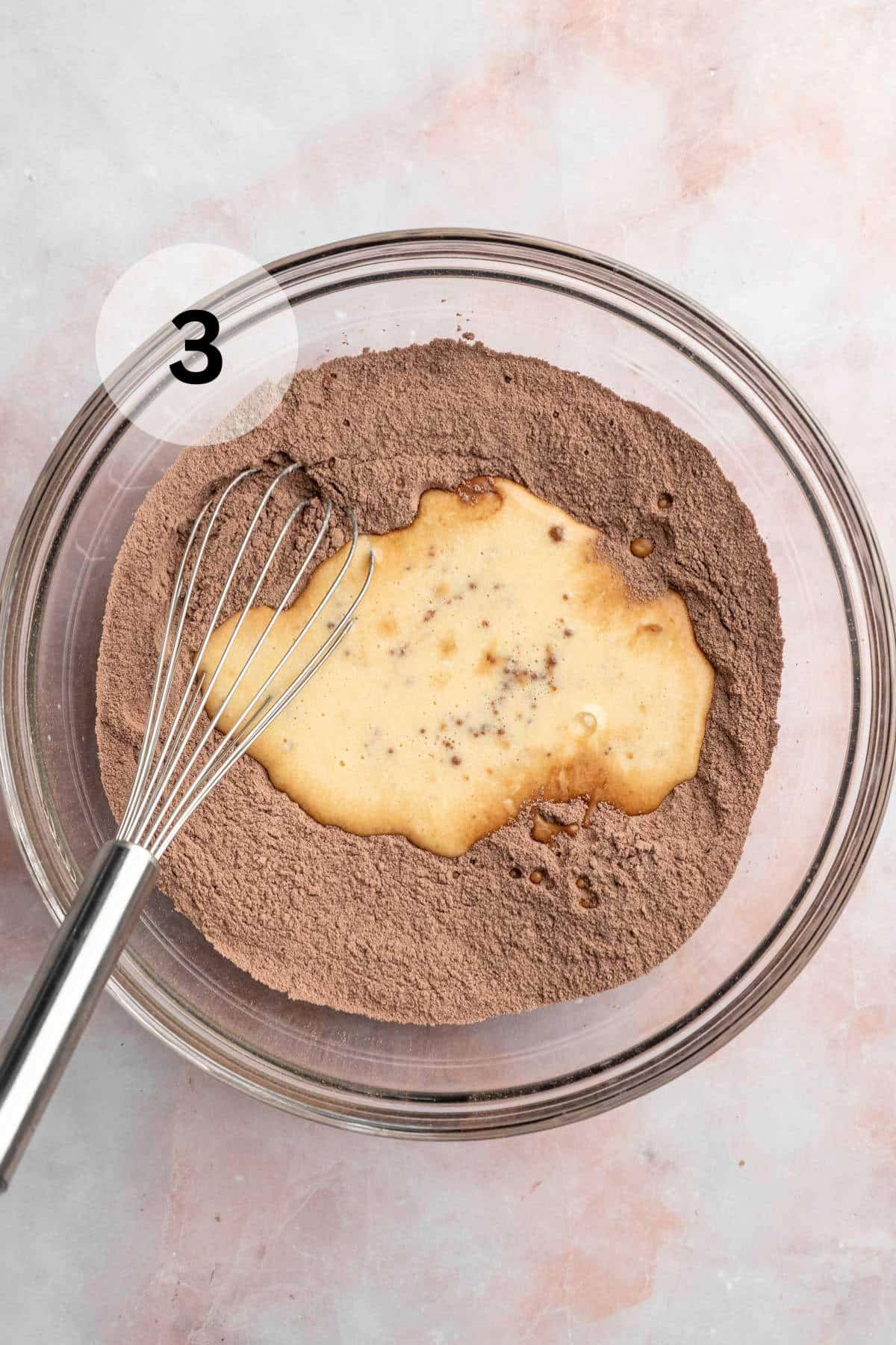 Using a whisk to combine wet and dry ingredients in one bowl.