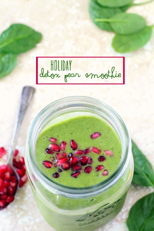 green smoothie in mason jar topped with pomegranate seeds