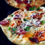This rustic fall harvest naan pizza recipe features seasonal ingredients including sweet potato, apple, crisp bacon and caramelized onion. The perfect dinner for a cozy night by the fire!