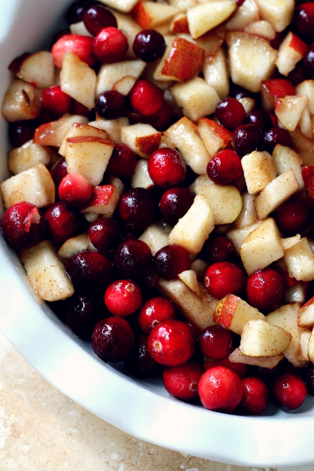 cranberries and chopped pear in a white pie plate
