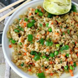 This Easy Cauliflower Fried Rice recipe is super healthy, full of veggie goodness and packed with protein. It comes together in less than 20 minutes and is completely customizable. Go vegetarian or add chicken, fish, shrimp, you name it!