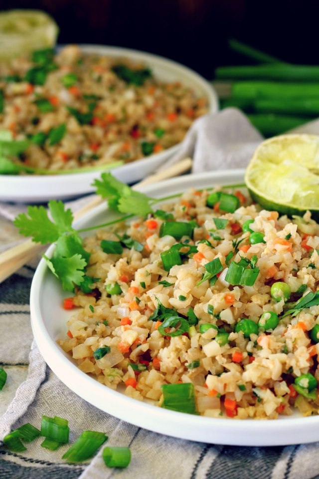 This Easy Cauliflower Fried Rice recipe is super healthy, full of veggie goodness and packed with protein. It comes together in less than 20 minutes and is completely customizable. Go vegetarian or add chicken, fish, shrimp, you name it!