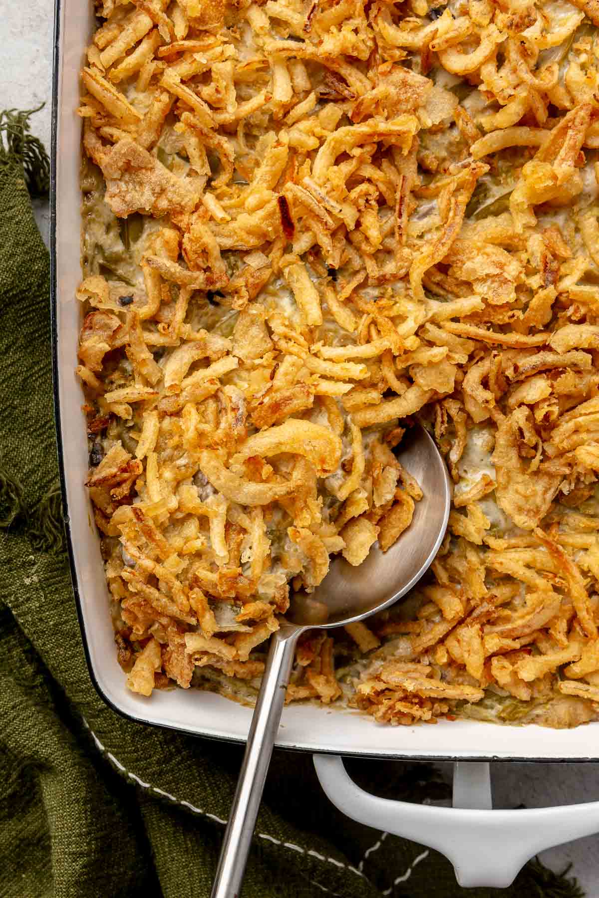 Green bean casserole topped with crispy onions.