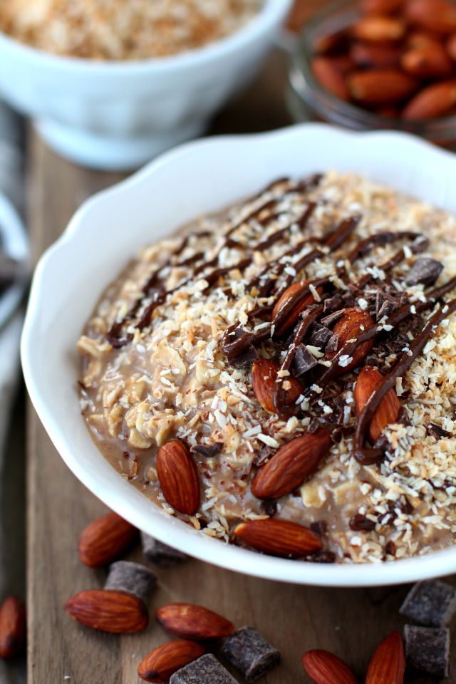 Overnight Oatmeal in a white bowl topped with almonds and chocolate syrup