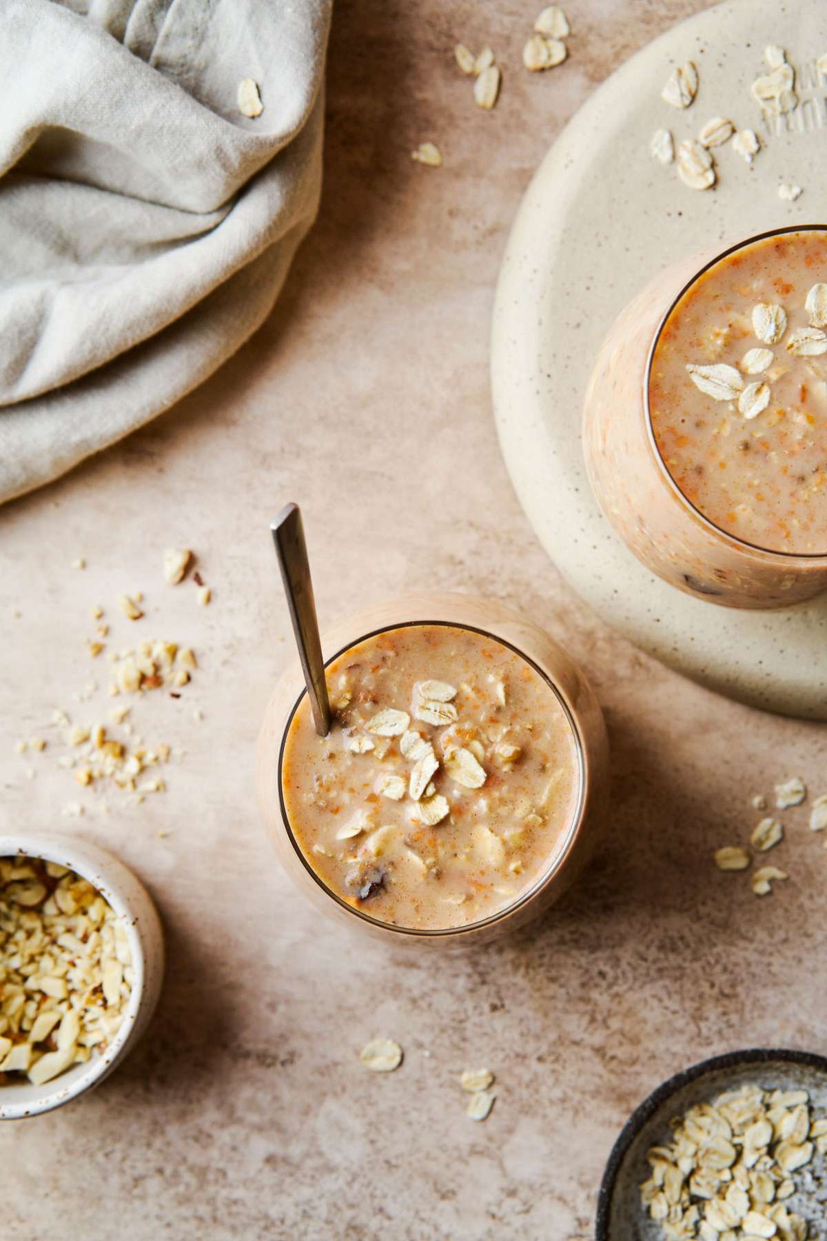 Overnight oats in a small glass with a spoon.