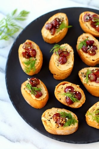 Roasted Grape Caramelized Onion Hummus Crostini - This appetizer is bursting with flavor and is a crowd-pleaser at any event! {vegan & gluten-free}
