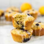 two lemon blueberry muffins with icing stacked