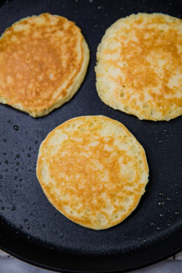 cooking pancakes on a large skillet