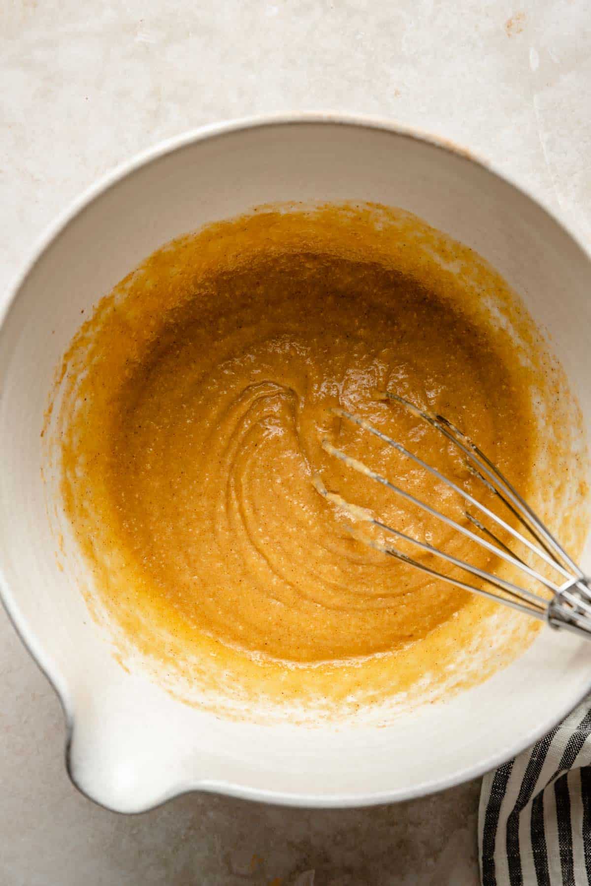 Whisking coconut flour with butter and eggs.