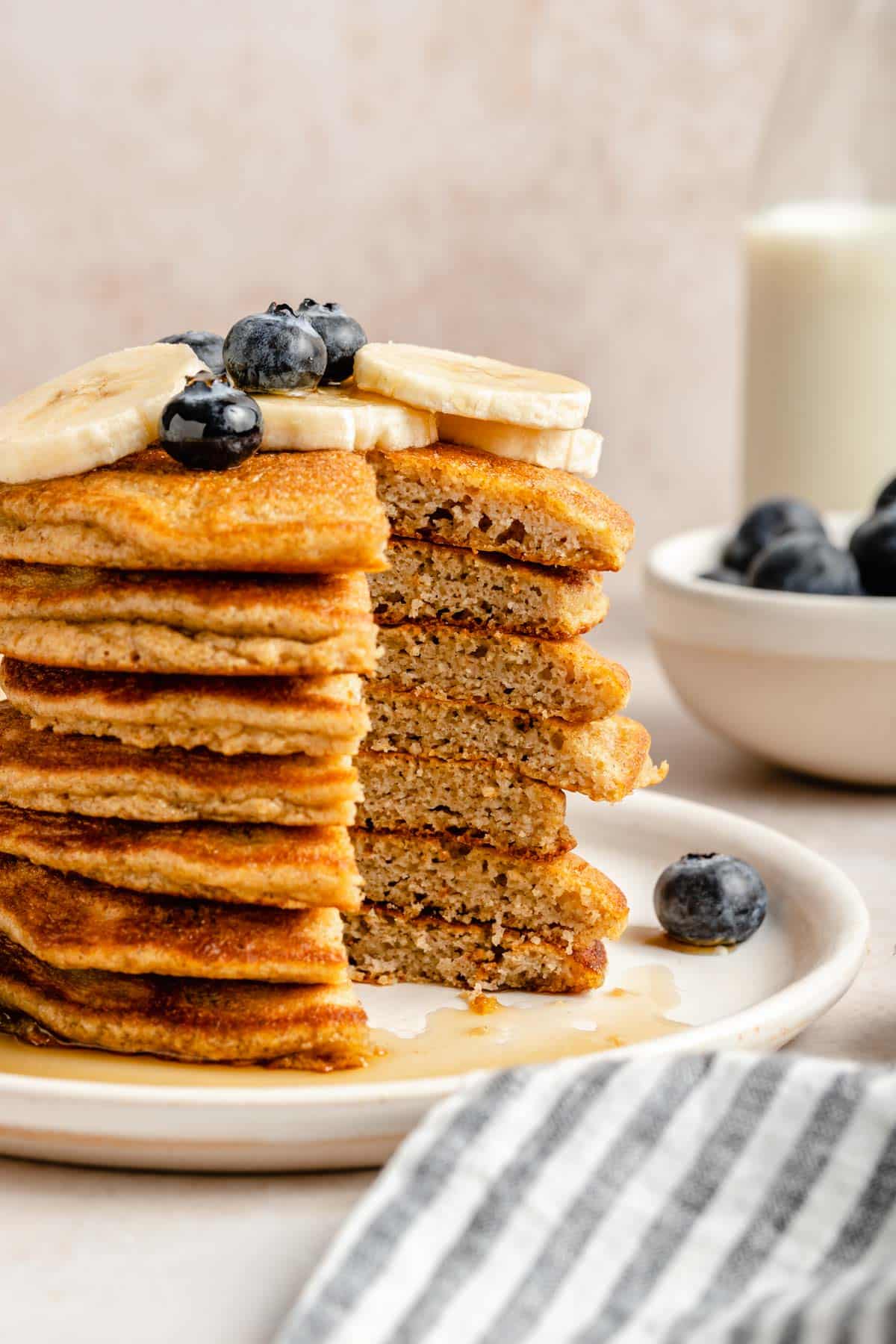 Stack of coconut flour pancakes with a bite taken out.