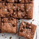 Protein brownies topped with chocolate chips and flaky sea salt.