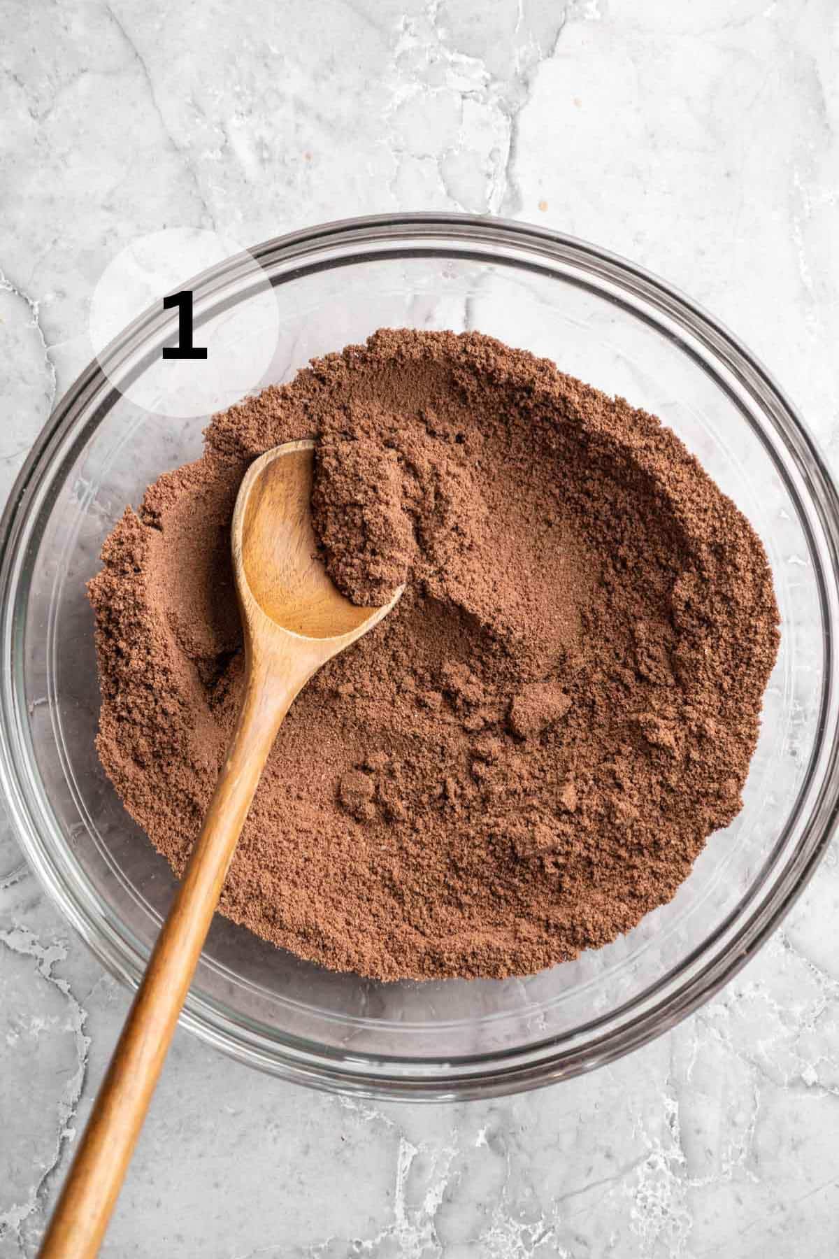 Whisking together almond flour, protein powder, unsweetened cocoa powder, baking powder, and salt.