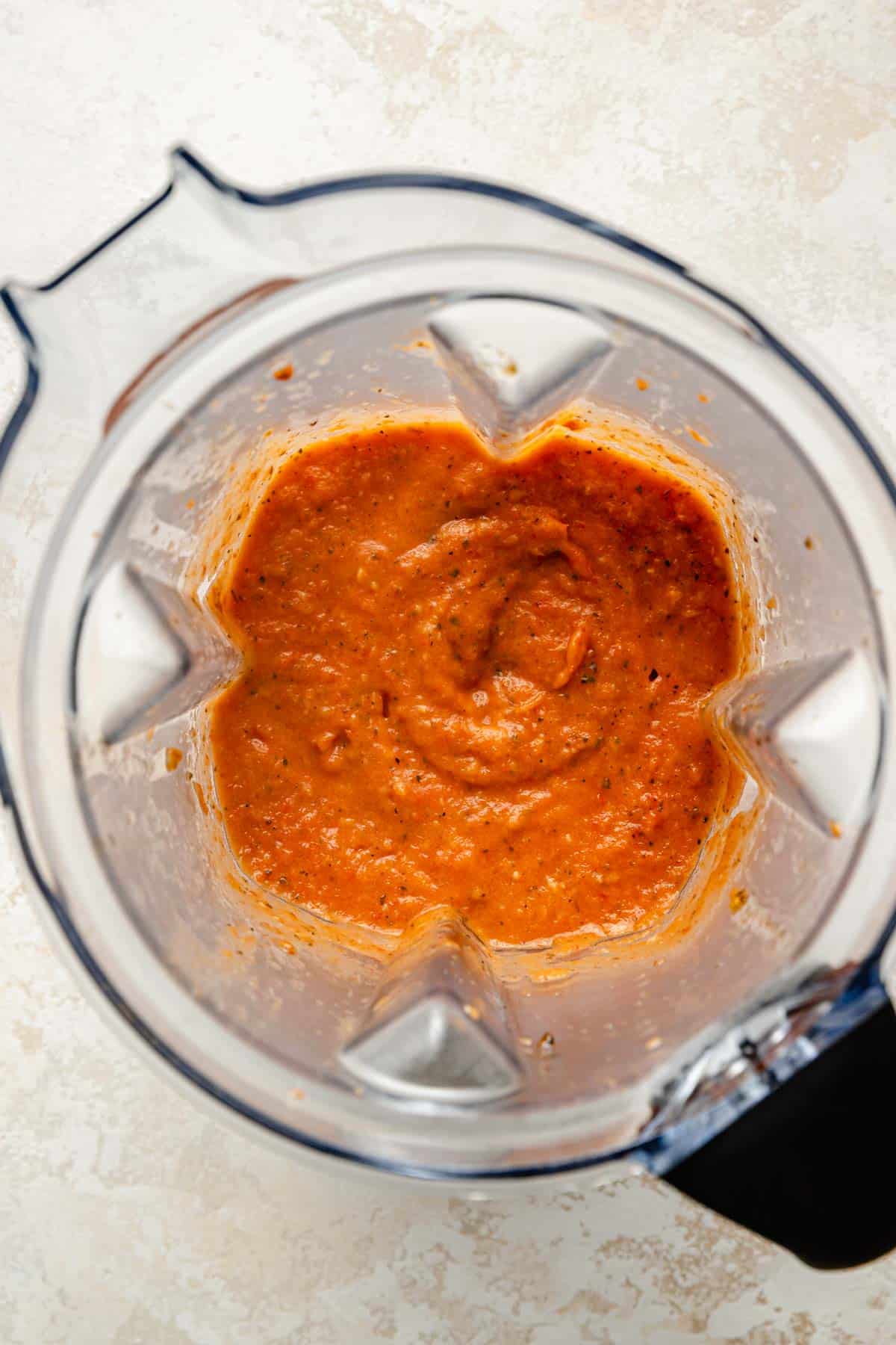 Blending tomato sauce in a blender.