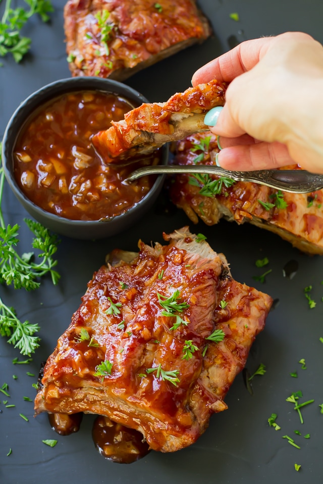 Grilled Sriracha Ribs are falling off the bone amazing, cooked on the grill and smothered in an irresistible saucy Sriracha sauce! Who knew you could enjoy amazing ribs, right at home?