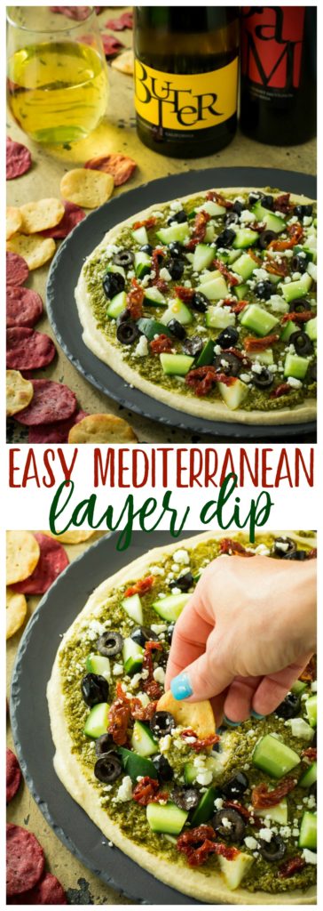 A healthy, tasty, easy Mediterranean layer dip recipe that is a great appetizer or wholesome snack. Loaded with goodies, like hummus, pesto,  feta, olives and sun-dried tomatoes.