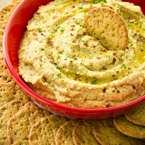 Easy 10 minute Super Flavorful Ranch Hummus is so creamy dreamy irresistibly delicious. And I'm warning you, it's quite addictive!! Not only is this an amazing and easy dip, it works fantastic as a spread for a sandwich or roll-up as well.