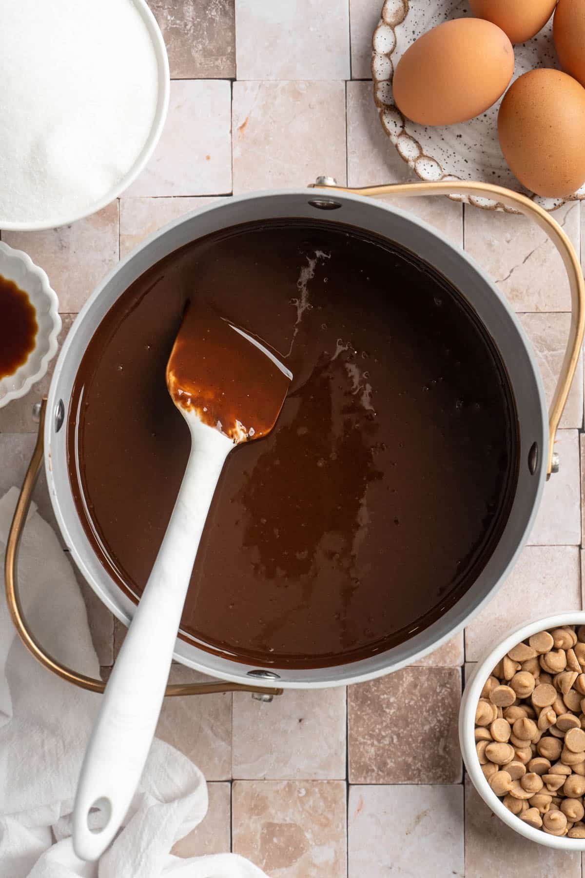 Melting together peanut butter, chocolate and cocoa in a pot.