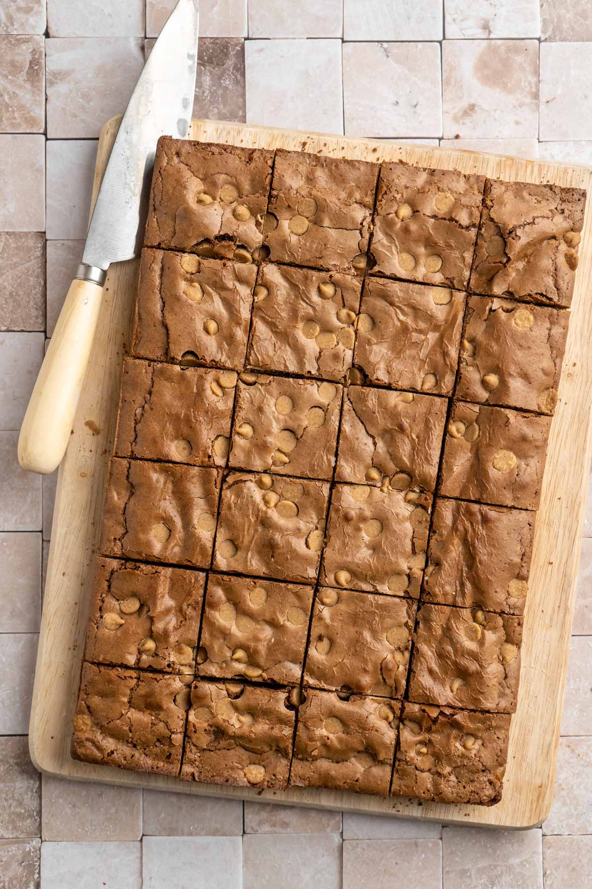 Brownies cut into squares on a cutting board.