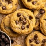 Pumpkin chocolate chip cookies on parchment paper.