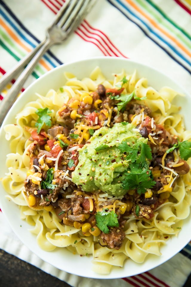 Looking for an EASY dinner that is extremely delicious too? This Bison Taco Chili Over Noodles is your recipe! It's like your favorite taco turned into a cozy chili recipe!