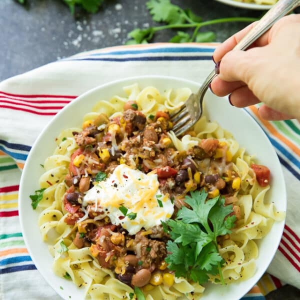Looking for an EASY dinner that is extremely delicious too? This Bison Taco Chili Over Noodles is your recipe! It's like your favorite taco turned into a cozy chili recipe!