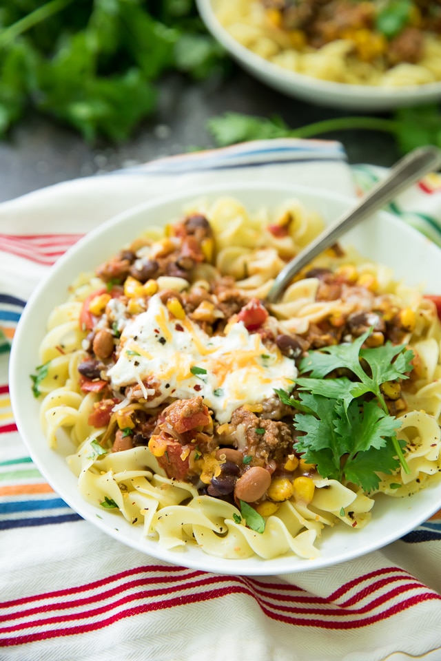 Looking for an EASY dinner that is extremely delicious too? This Bison Taco Chili Over Noodles is your recipe! It's like your favorite taco turned into a cozy chili recipe!