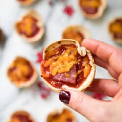 These crowd pleasing Mini Party Pizzas are cheesy and delicious! They're the perfect easy recipe for serving at your next party, game day or tailgate!