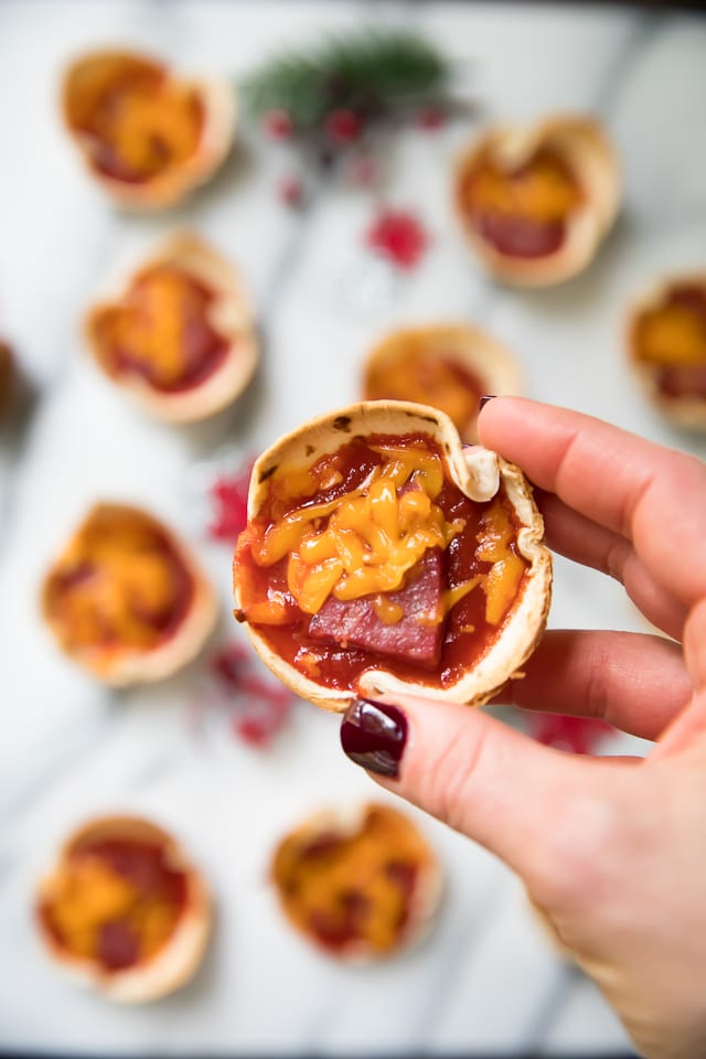 These crowd pleasing Mini Party Pizzas are cheesy and delicious! They're the perfect easy recipe for serving at your next party, game day or tailgate!