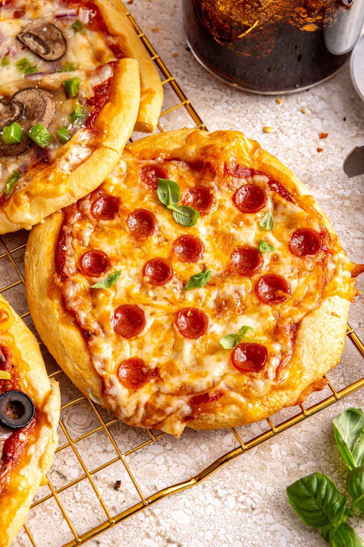 Mini pizza topped with mini pepperonis.