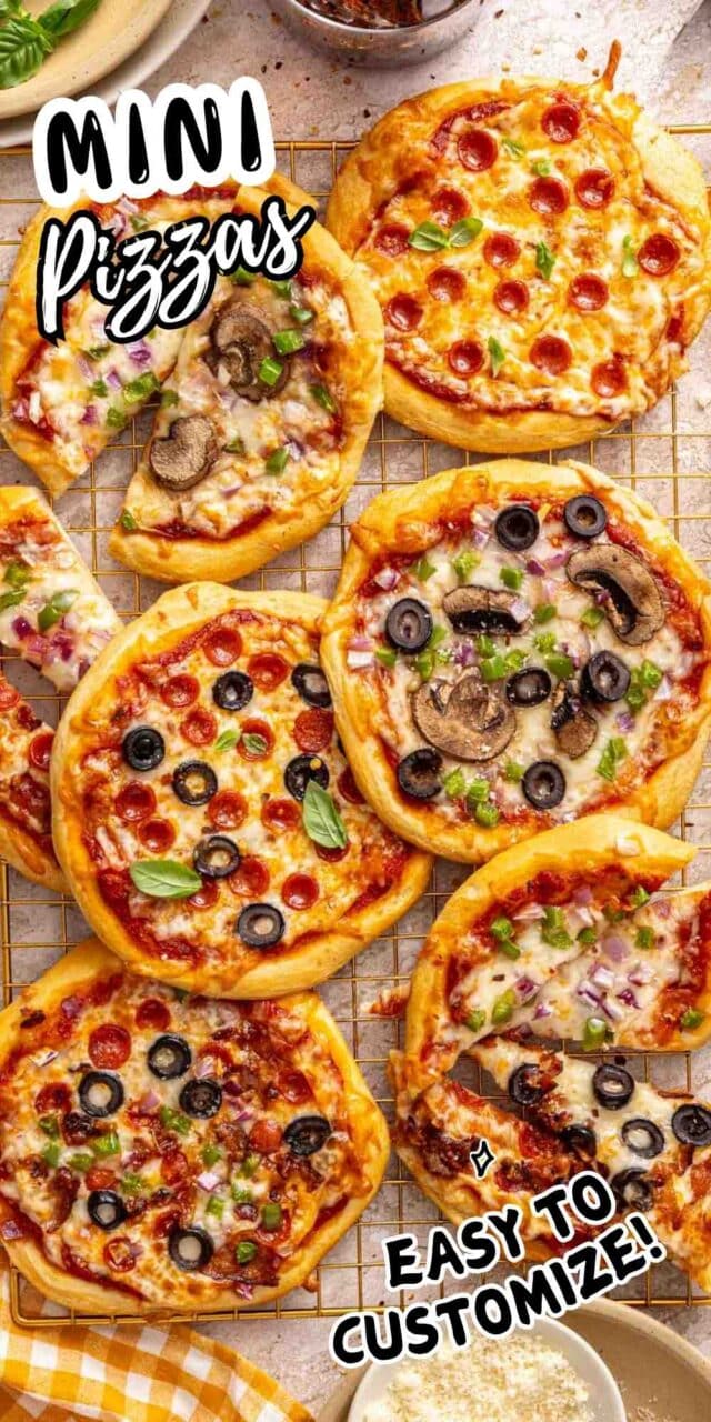 Mini pizzas with assorted toppings on a wire rack.