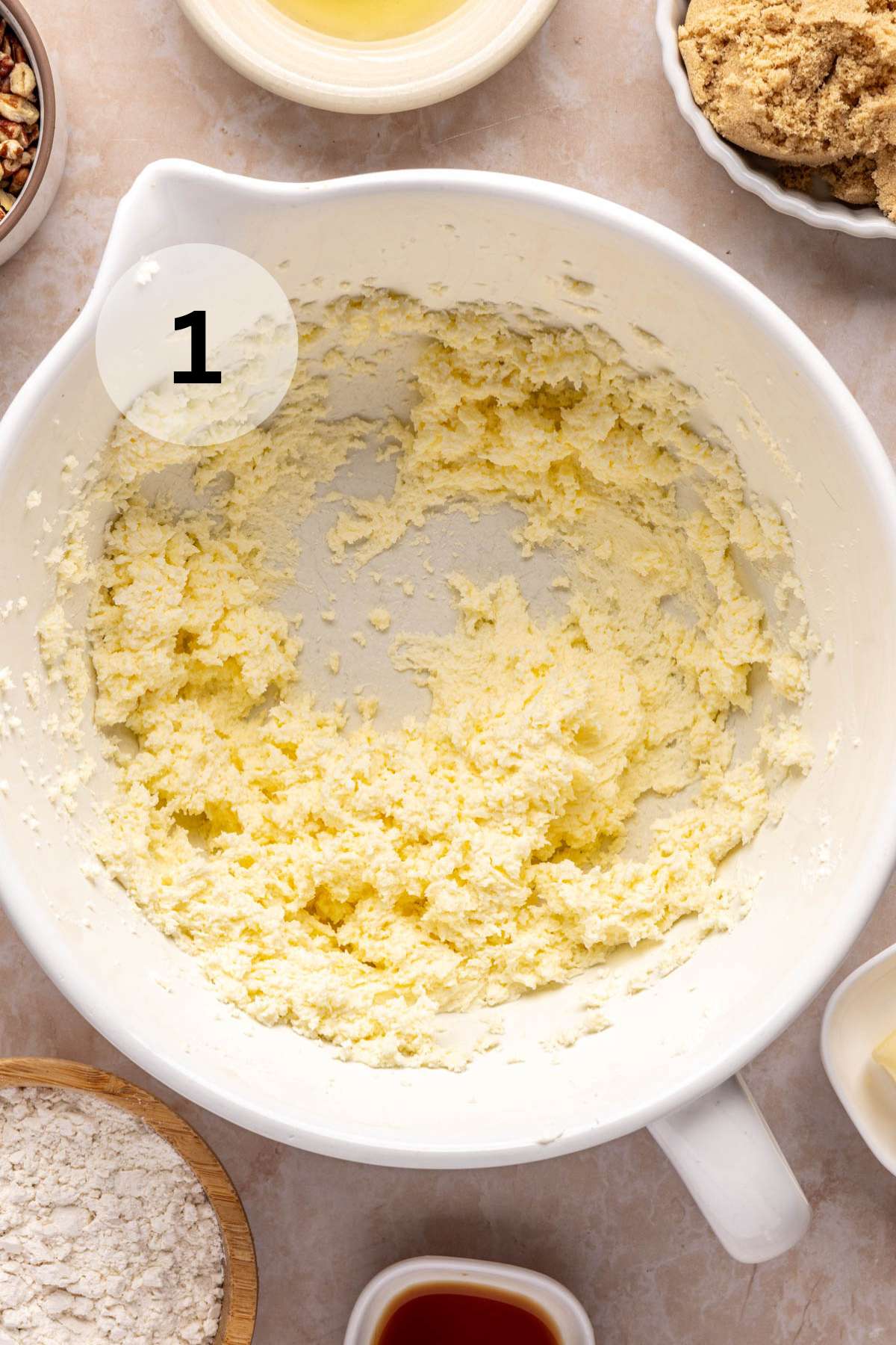 Cream cheese and butter mixed in a white mixing bowl.